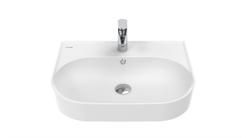 Weißes Waschbecken mit abgerundeter Form und mittiger Armaturenbohrung.